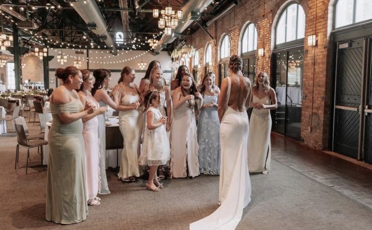 Bride revealing her wedding look to her bridal party
